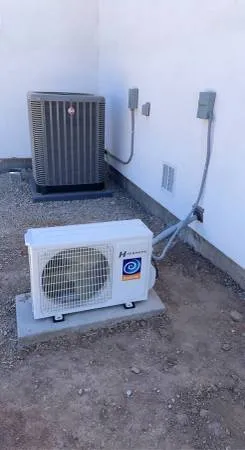 Condenser and mini split outdoor unit on a gravel pad
