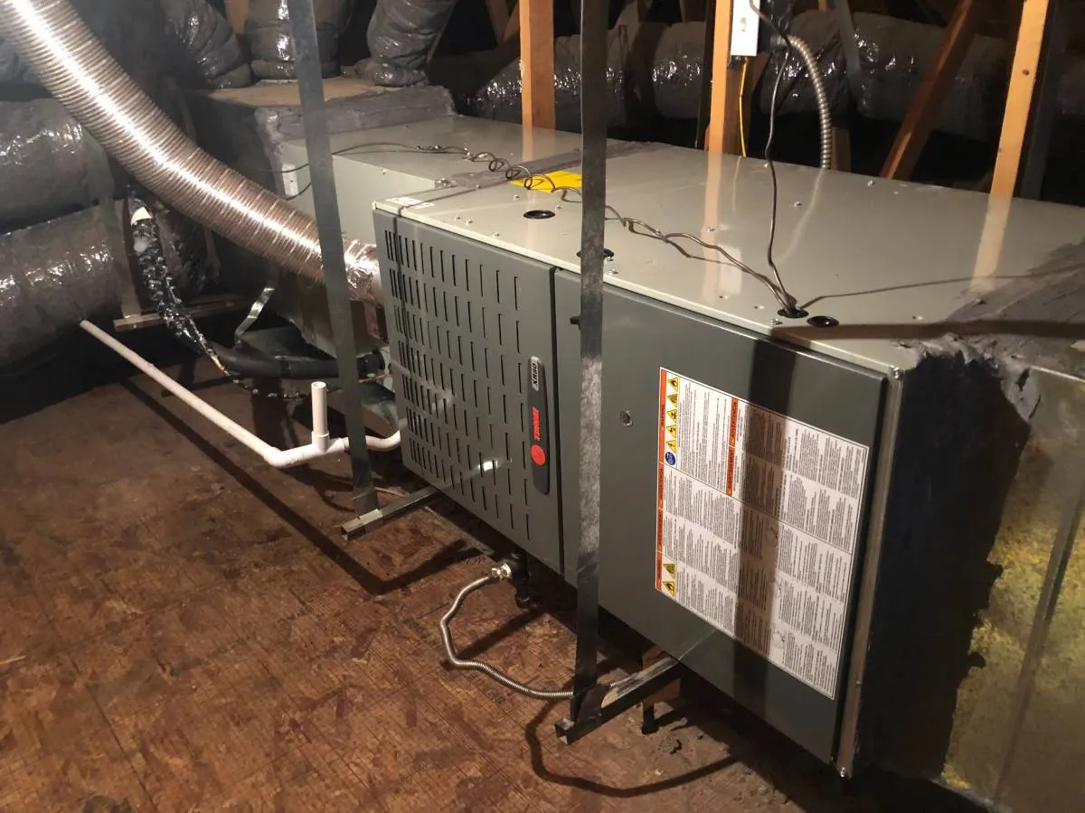Air handler and ductwork serviced in a home attic