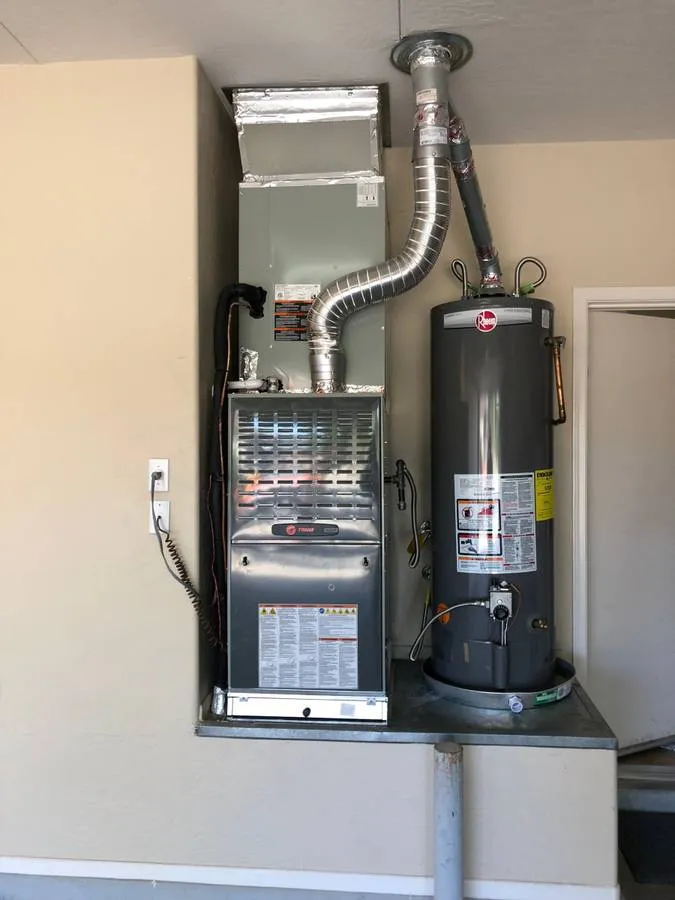 Gas furnace installed in a garage next to the water heater